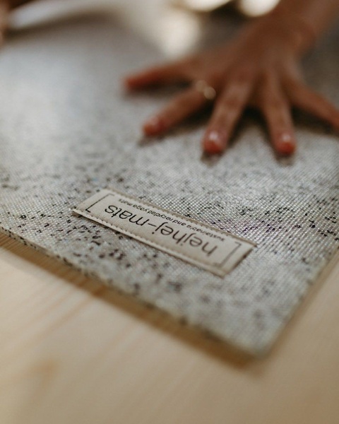 A close-up, high-detail shot of a recycled yoga mat focusing on texture and material quality under natural lighting.